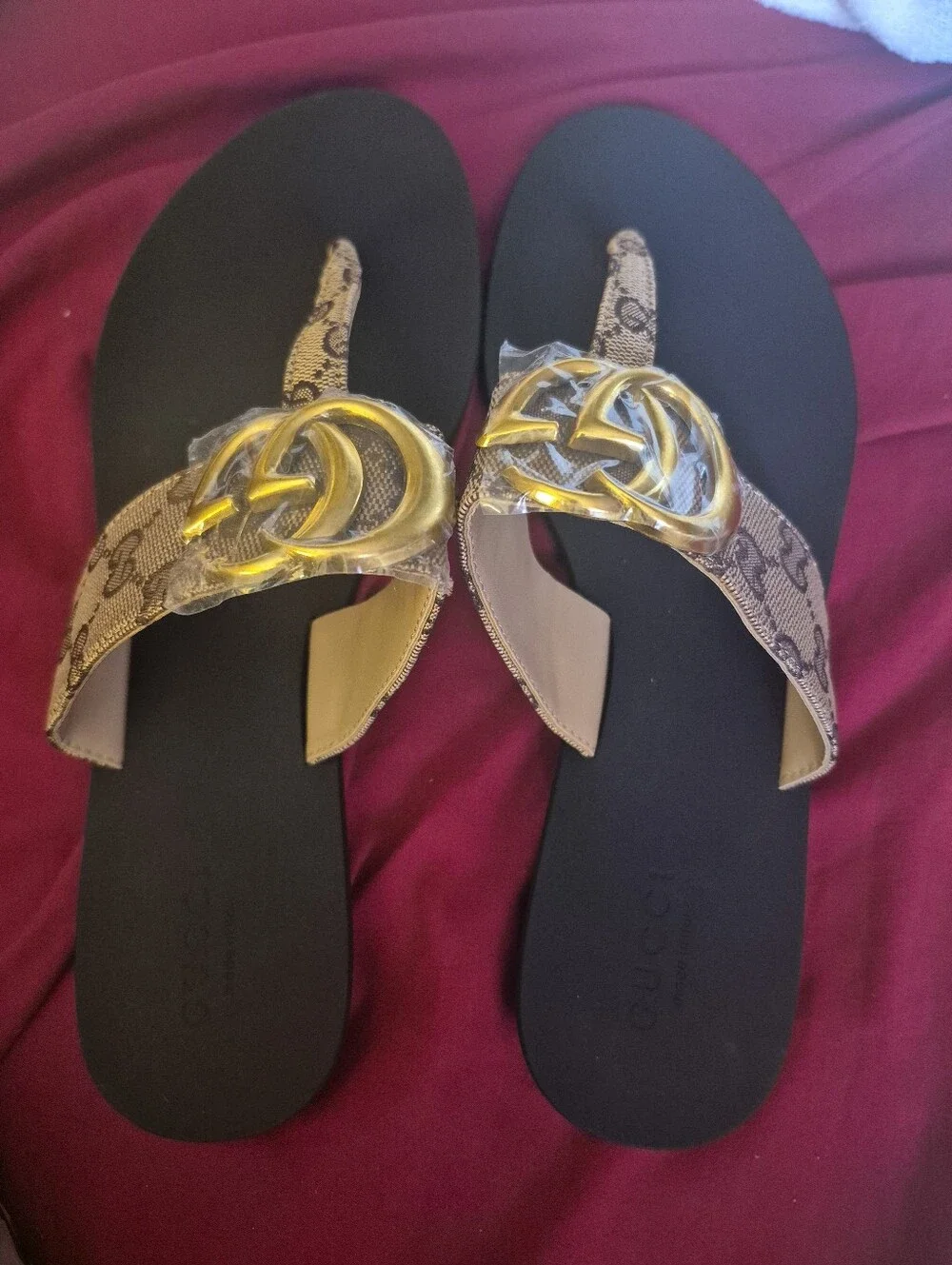 Source Unknown Black Thong Sandals with Gold Emblem and Beige Patterned Straps